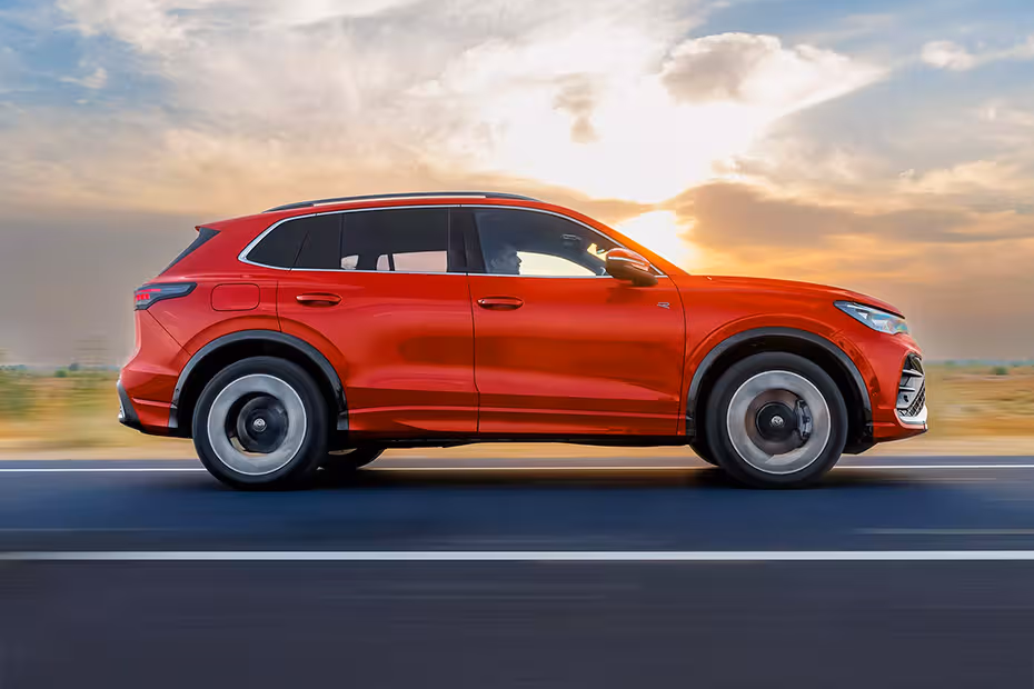Volkswagen Tiguan R line 2025 on The wait is over! Volkswagen India has launched the all-new Tiguan R-Line, a bold, performance-focused premium SUV priced at ₹49 lakh (ex-showroom). Offered in a single, fully-loaded variant, this SUV comes as a completely built unit (CBU) and is ready to take on the luxury SUV segment in style and substance.  Built on Volkswagen’s updated MQB Evo platform, the new Tiguan R-Line brings a blend of power, comfort, intelligent tech, and signature German engineering. 🚘 Exterior: Sleek, Sporty & Striking  The Tiguan R-Line grabs attention from every angle. Up front, it features sleek headlamps connected by a glass-covered LED strip, proudly carrying the exclusive "R" badge. A bold chrome insert on the bumper and a massive black mesh lower grille add aggression, while the diamond-cut 19-inch “Coventry” alloys enhance its road presence.  The SUV features dynamic 3D LED tail-lamps, a connected LED light bar, dual exhaust tips, and "TIGUAN" + "4MOTION" badging, emphasizing its all-wheel-drive prowess. The sporty black cladding and sharp lines complete the performance aesthetic. 🖤 Interior: Tech-Filled, Blacked-Out, and Driver-Focused  Inside, the cabin is a blend of premium materials and advanced tech. It features an all-black theme with piano black and brushed silver inserts, ambient lighting, and even animations on the dashboard screen.  The “ErgoActive” front seats come with massage function and lumbar support, wrapped in a stylish leather-fabric combo. The leather-wrapped steering wheel with paddle shifters, customisable 10.25-inch digital cockpit, and head-up display ensure a driver-centric experience.  The 15-inch touchscreen infotainment controls most in-car functions, with support for Wireless Apple CarPlay, Android Auto, and an IDA voice assistant. An 8-speaker audio system, triple-zone climate control, heated seats, ambient lighting, and wireless charging slots for two smartphones keep everyone comfortable and connected. 🔒 Safety & Tech: Loaded with Intelligence  Volkswagen has equipped the Tiguan R-Line with 21 Level 2 ADAS features, including adaptive cruise control, lane assist, autonomous emergency braking and more. The car is also fitted with 9 airbags, Hill Start Assist, Hill Descent Control, TPMS, and a 5-star Euro NCAP safety rating for peace of mind. ⚙️ Performance: Where Engineering Meets Excitement  Under the hood, the Tiguan R-Line packs a 2.0L TSI petrol engine producing 201 BHP and 320 Nm of torque. Paired with a 7-speed DSG automatic and Volkswagen's 4MOTION all-wheel-drive system, this SUV offers dynamic handling and grip.  It also features Dynamic Chassis Control (DCC Pro) and Vehicle Dynamics Manager (XDS), which actively manage damping and braking on each wheel to deliver a composed and confidence-inspiring drive—even on twisty roads.  Fuel efficiency is rated at 12.58 km/l, which is decent for a full-size SUV in this segment. 📐 Dimensions & Boot Space: Spacious & Practical      Length: 4,539 mm      Width: 1,859 mm      Height: 1,656 mm      Wheelbase: 2,680 mm      Ground Clearance: 176 mm      Kerb Weight: 1,758 kg      Boot Capacity: 652 litres (expandable to 1,650 litres)      Turning Radius: 5.85 m  Also included is an 18-inch space-saver spare wheel and a puncture repair kit. 🎨 Colour Options: Stand Out in Style  Choose from 6 striking colours:      Persimmon Red Metallic      Grenadilla Black Metallic      Oryx White Pearl      Nightshade Blue Metallic      Oyster Silver Metallic      Cipressino Green Metallic  ✅ Final Thoughts: Is the Tiguan R-Line for You?  If you're in the market for a premium SUV that offers German engineering, bold design, intelligent safety tech, and sporty driving dynamics, the new Volkswagen Tiguan R-Line is a compelling option.  And at Carbae, we’re here to make your new car buying experience smooth, fast, and hassle-free. Compare prices, discover exclusive showroom offers, and book test drives—all from one place. Carbae helps you buy your car the smart way.  Ready to drive home the all-new Tiguan R-Line? Discover showroom deals near you now on Carbae.in 🚗